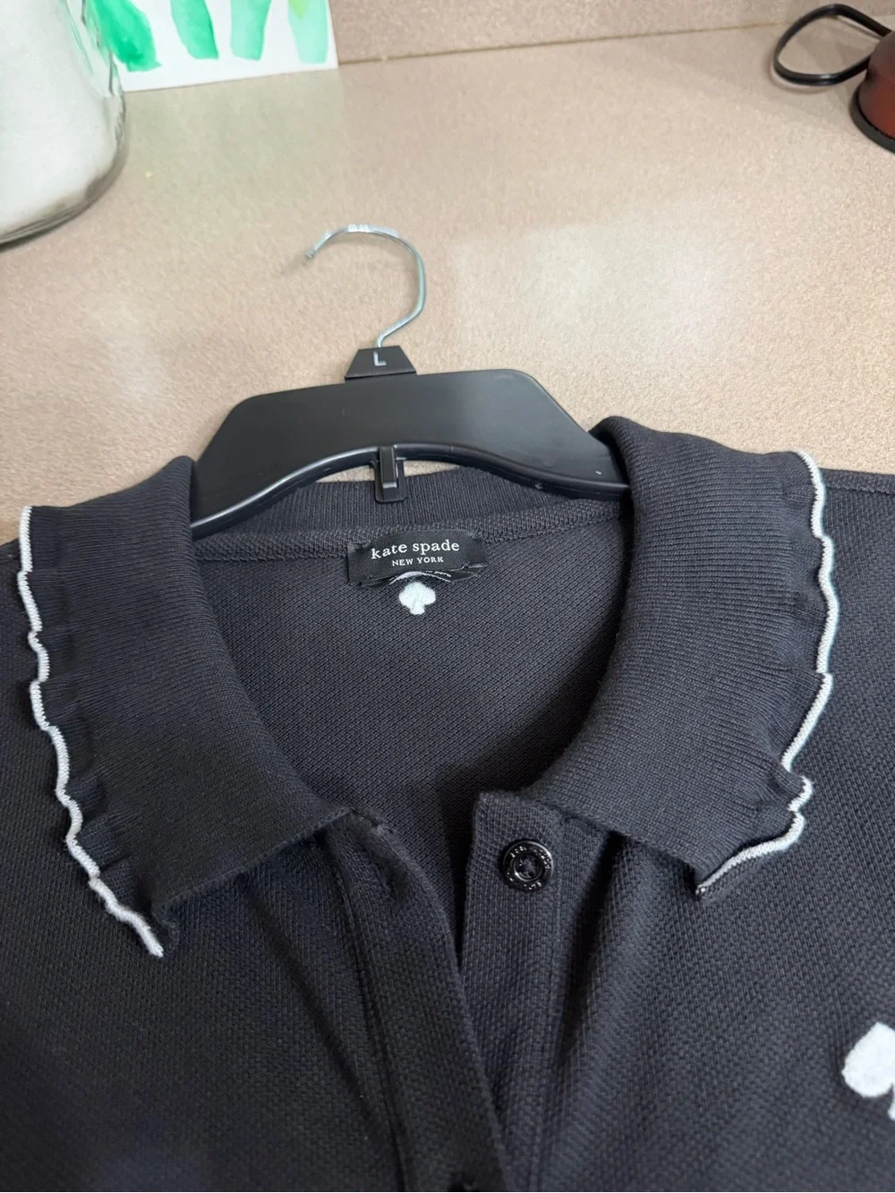 kate spade black polo top with white trim and embroidered logo.